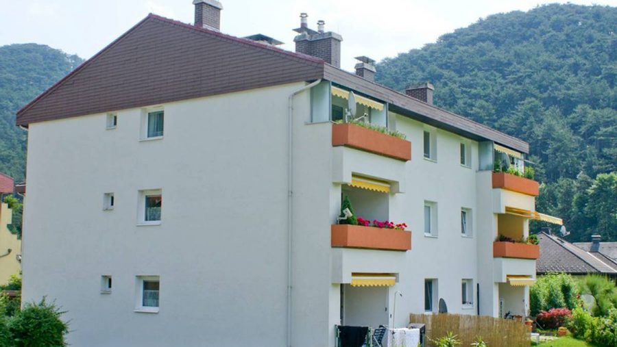 Modernes Mehrfamilienhaus mit Balkonen in ruhiger Lage, ideal für Wohnungskäufer in der Umgebung.